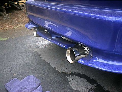 1993 Ford Probe - Close-up of a blue car's rear bumper and dual exhaust tips.