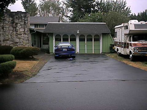 1993 Ford Probe - A blue 1993 Ford Probe is parked in a driveway next to a motorhome.