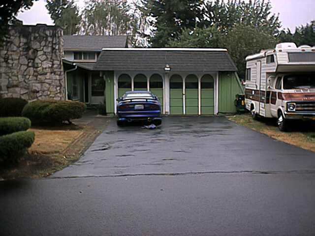 Blue 1993 Ford Probe rear view parked in driveway