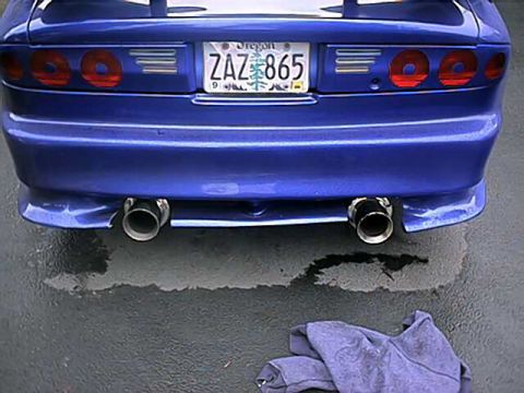 1993 Ford Probe - The rear of a blue vehicle shows dual exhaust pipes and a license plate from Oregon.