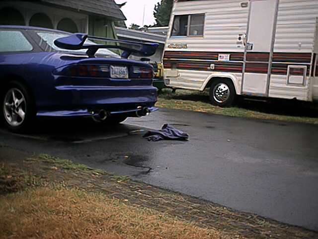 Blue 1993 Ford Probe rear view with spoiler and dual exhaust