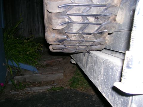 2003 Jeep TJ - A close-up view of a vehicle's tire and frame, focusing on the tread pattern.