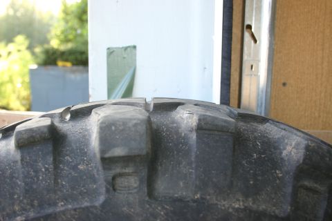 2003 Jeep TJ - Tire tread detail, likely from an off-road vehicle, showing deep lugs.