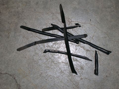 2003 Jeep TJ - Collection of metal tire studs on a concrete surface.