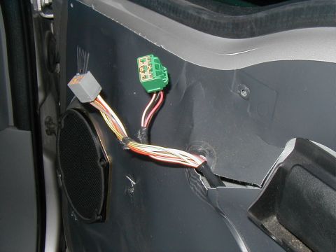 2002 Ford Excursion - Close-up of car door wiring harness and speaker assembly, showing electrical connectors.