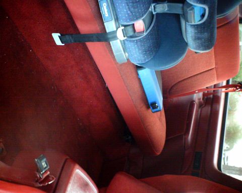 1989 Ford Bronco - Interior view of a vehicle with a child car seat installed.