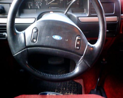 1989 Ford Bronco - Interior view of a 1989 Ford Bronco, showing the steering wheel and dashboard details.