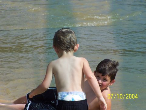 1987 Ford Bronco - Two boys enjoy a day in the water, with one looking towards the viewer.