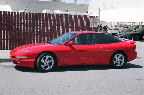1997 Ford Probe - Side profile of a red 1997 Ford Probe coupe parked outdoors.