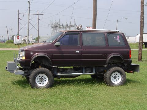 1991 Ford Bronco - This modified minivan sits high on off-road tires, a custom front bumper and side steps.