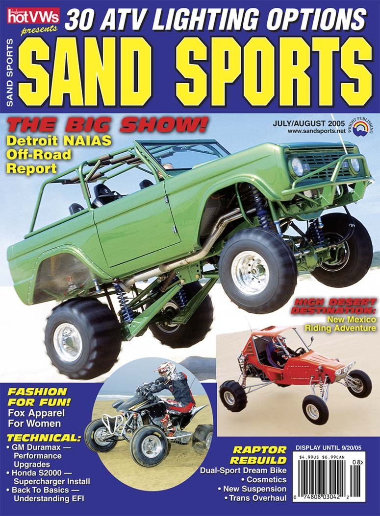 Green lifted off-road vehicle with large tires, front view