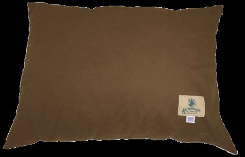 1993 Ford Bronco - A close-up view of a brown pillow with a small tag visible on its surface.
