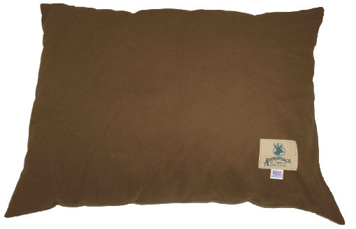 Brown pillow with a small tag on the lower right corner