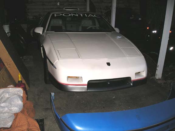 1984 Pontiac Fiero front view in garage. Pontiac lettering on windshield