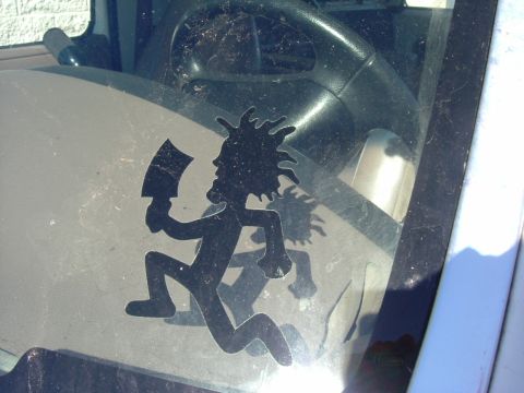 1993 Ford Bronco - A decal of a character holding a cleaver is adhered to the interior of a vehicle's windshield.