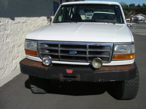 1993 Ford Bronco - This 1992 Ford Bronco shows a rusty bumper and auxiliary lights on its front grille.