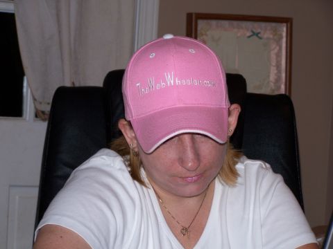1979 Ford F-150 - A person wears a pink baseball cap with embroidered text, obscuring their face.