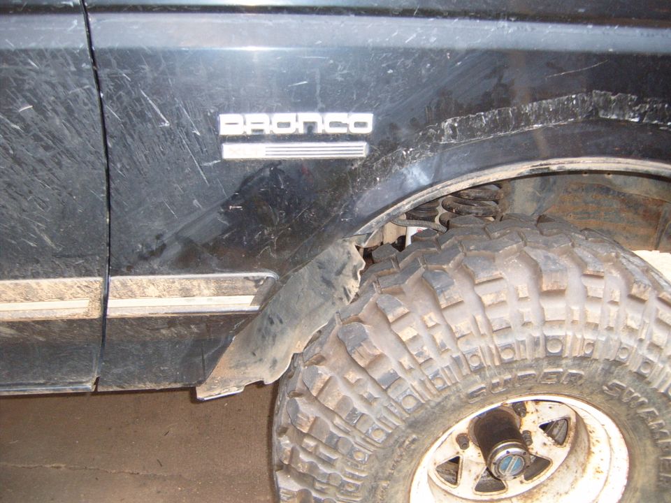 1988 Ford Bronco side view showing fender trim and large off-road tire