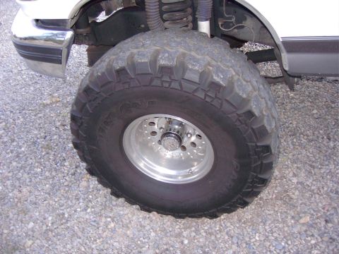 1992 Ford F-150 - Close-up of the front wheel and chrome bumper on a 1992 Ford F-150.