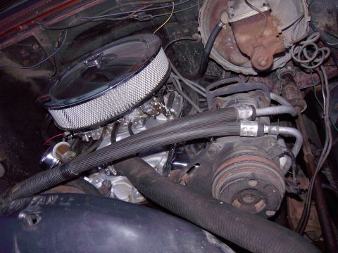 1992 Ford F-150 - Close-up view of an engine bay, a chrome air cleaner and various hoses and components.