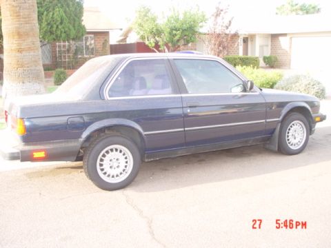 1992 Ford F-150 - Side view of a dark blue coupe with a visible timestamp and website watermark.