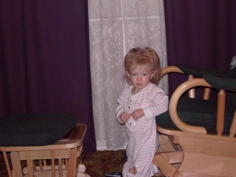 1992 Ford F-150 - A young child in striped pajamas stands indoors next to furniture.
