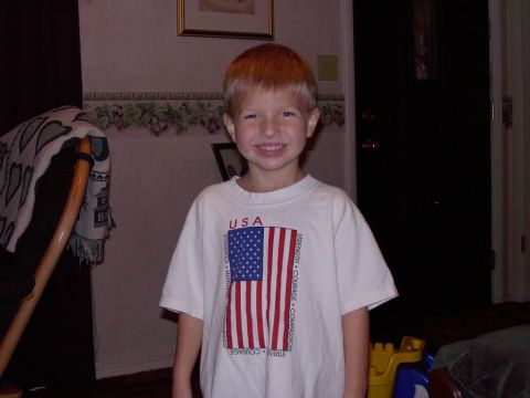 1992 Ford F-150 - A young child smiles while wearing a white t-shirt with the American flag and the word USA printed on it.