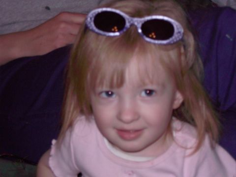 1992 Ford F-150 - A young child is posing for a photo with a pair of sunglasses perched on top of her head.