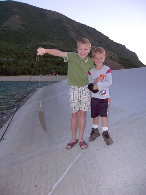 1992 Ford F-150 - Two boys proudly display their catch of the day while fishing near a lake.