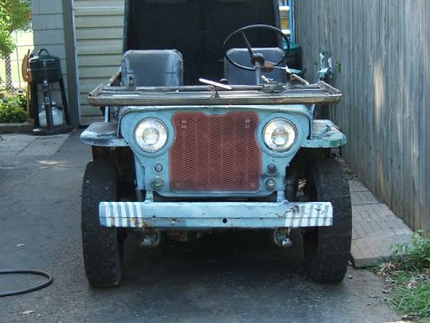 1950 Jeep CJ5 - This Jeep CJ-3A, seen from the front, has a distinctive grille and appears to be in a state of disrepair.
