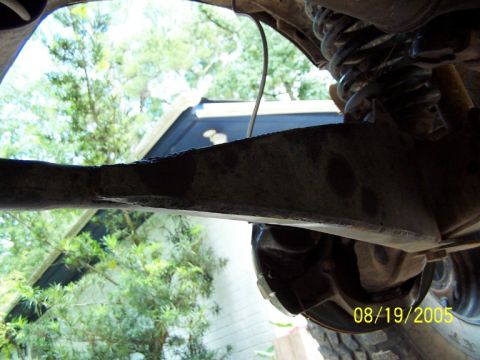 1987 Ford Bronco - This photo shows the underside of a vehicle, focusing on suspension parts and a date stamp from 2005.