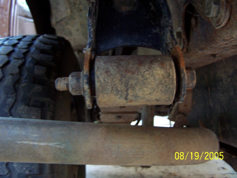 Close-up of rusty suspension bushing and bolt