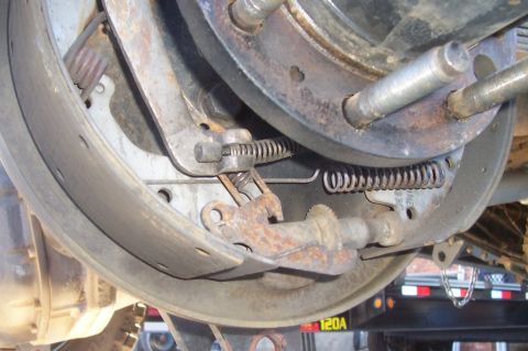 1994 Ford F-150 - Close-up view of a vehicle's rear axle drum brake system, showing internal components and springs.