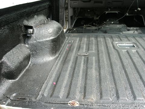1994 Ford Bronco - Interior view of a truck bed with a textured black liner applied.