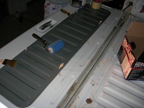 1994 Ford Bronco - Tools and supplies are laid out for applying a protective coating to a vehicle's interior panel.