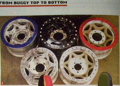 1995 Ford Bronco - Collection of five aftermarket wheels, some with colored rims, displayed together.