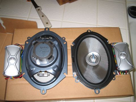 1993 Ford Probe - Two car speakers, one Infinity and one Pioneer, are laid out on a cardboard box.