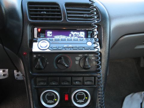 1993 Ford Probe - The interior dashboard features an aftermarket stereo and auxiliary gauges, with no clear year identification.