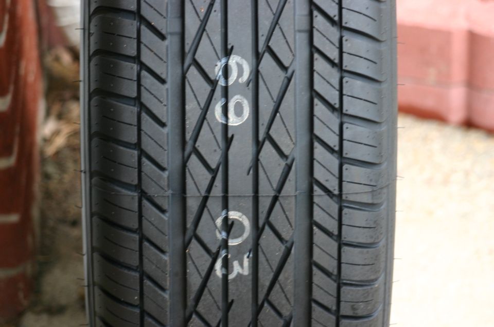 Tire tread with white markings '66' and '03' visible
