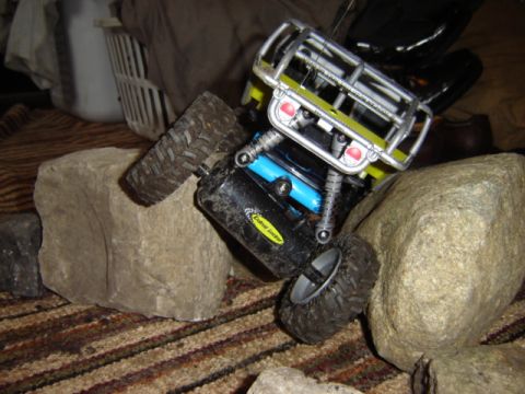 1992 Ford Bronco - A toy rock crawler is shown navigating a rocky obstacle course indoors.