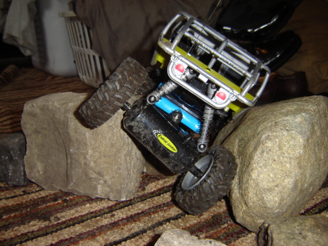 toy rock crawler stuck on rocks, has 'Extreme Locker' text