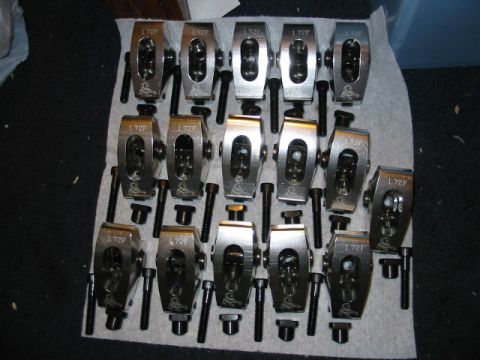 1985 Ford LTD Crown Victoria - Engine valve train components, including roller rocker arms and bolts, are neatly arranged.