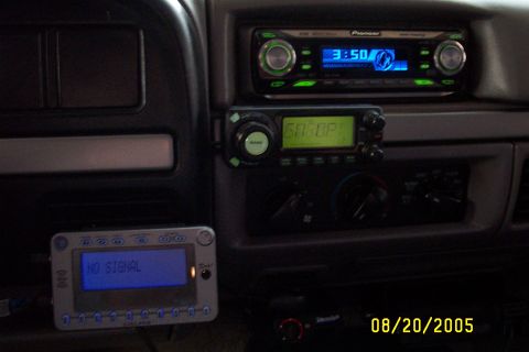 1995 Ford F-350 - Aftermarket electronics installed in a vehicle's dashboard, including a stereo and CB radio.