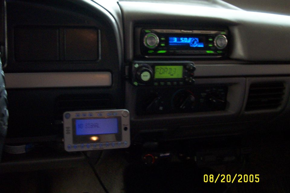 Dashboard of a truck with a Pioneer stereo, a CB radio, and a device showing 'NO SIGNAL'