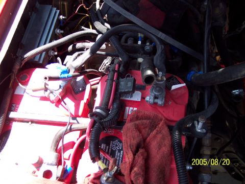 1985 Ford Bronco - Close-up view of a vehicle's engine bay, showing dual batteries and various components.