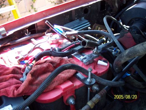 1985 Ford Bronco - Close-up view of a vehicle's engine bay, dual red batteries and various electrical components. A date stamp indicates the photo was taken o…