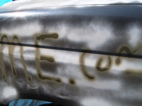 1988 Ford Bronco - A car body panel is shown with primer and spray-painted text.