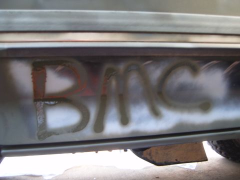 1988 Ford Bronco - Graffiti spelling 'BRONCO' is visible on the lower body panel of a vehicle.