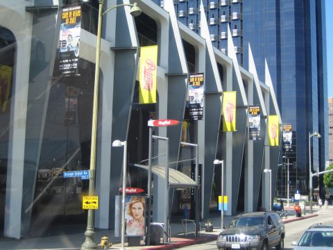 1968 Ford Mustang - The Petersen Automotive Museum exterior is shown with various banners and street signs visible.