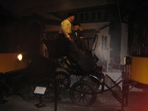 1968 Ford Mustang - A display features a vintage carriage with two mannequins, likely part of a museum exhibit.